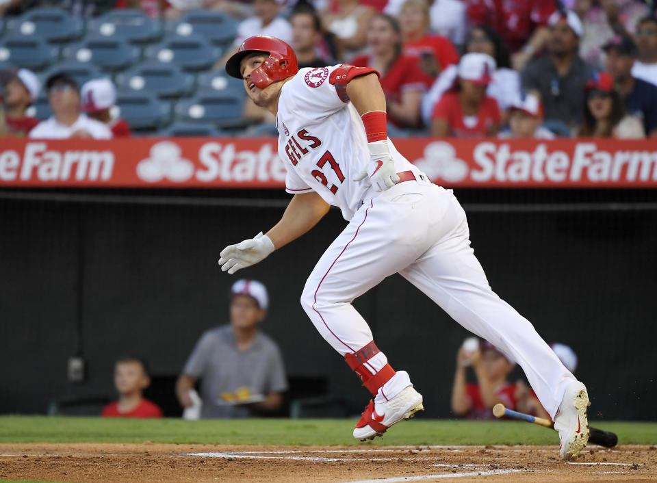 FILE - In this July 27, 2019, file photo, Los Angeles Angels' Mike Trout runs to first while watching his two-run home run during the first inning of the team's baseball game against the Baltimore Orioles in Anaheim, Calif. (AP Photo/Mark J. Terrill, File)