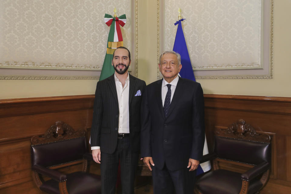 In this photo provided by the Mexican Presidency, EL Salvador's President-elect Nayib Bukele, left, poses for a photo with Mexico's President Andres Andres Manuel Lopez Obrador, during a meeting at the National Palace in Mexico City, Tuesday, March 12, 2019. (Mexican Presidency via AP)