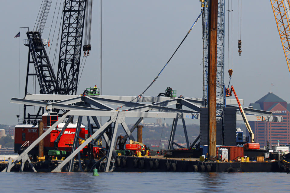 Salvage work continues on the collapsed Francis Scott Key Bridge, Monday, April 15, 2024, in Baltimore. The FBI confirmed that agents were aboard the Dali conducting court-authorized law enforcement activity. (AP Photo/Julia Nikhinson)