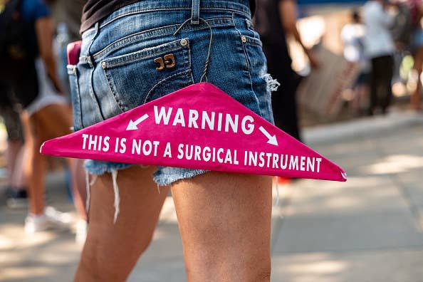 A clothing hanger that says "warning: this is not a surgical instrument"