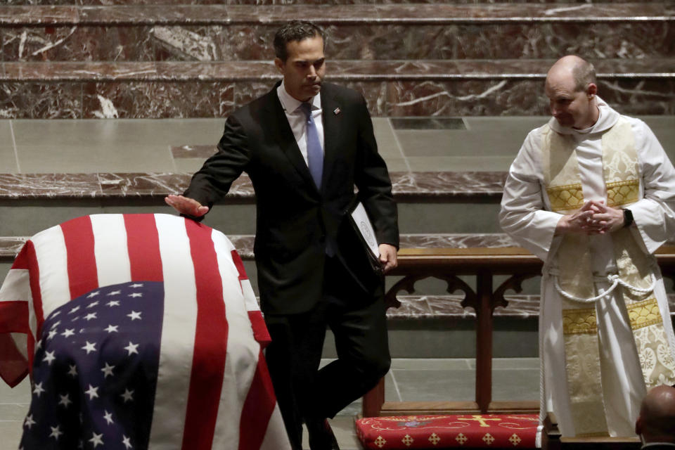 George P. Bush touches the flag-draped casket after giving a eulogy during a funeral for former President George H.W. Bush at St. Martin’s Episcopal Church Thursday, Dec. 6, 2018, in Houston. (Photo: Mark Humphrey/AP)