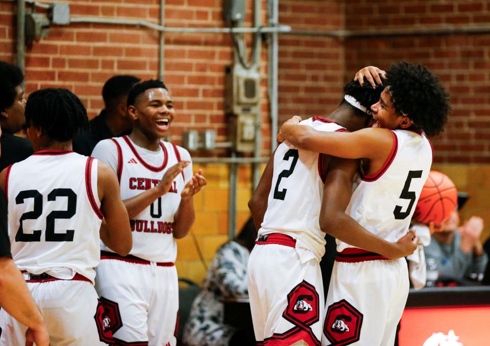 Central Bulldog Typique Brooks (2) is congratulated by teammates after he scored his 1,500th career point during a win on the Kickapoo Chiefs at "The Pit" on Tuesday, Jan. 30, 2024.