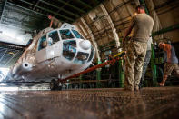 Members of the Ukrainian Aviation Unit deployed in the United Nations Mission in Liberia (UNMIL) load a helicopter into an Antonov cargo plane at Roberts International Airport, Liberia February 13, 2018. Albert Gonzalez Farran/UNMIL/Handout via REUTERS