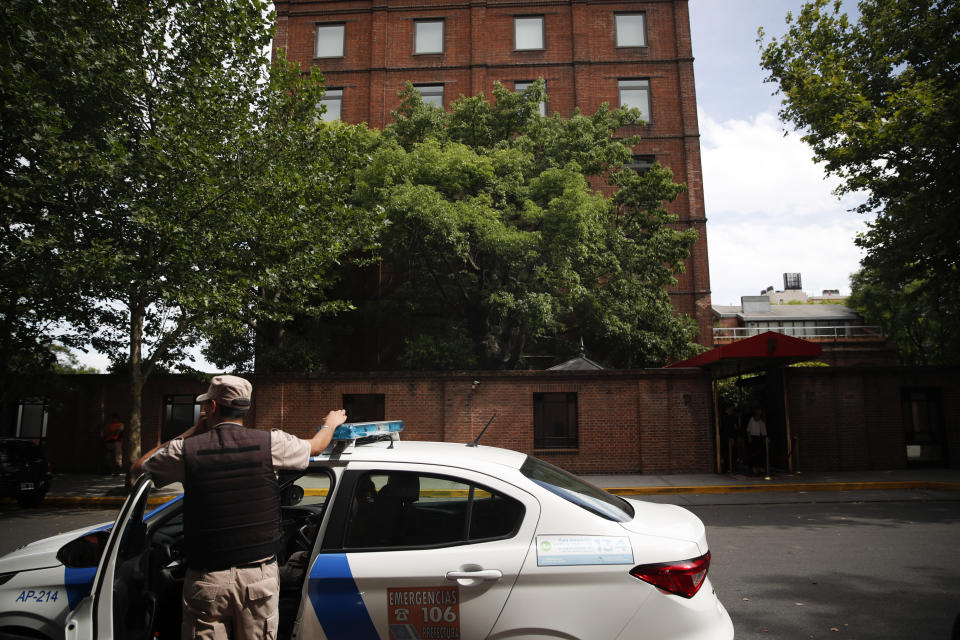 A police officer stands in front of the Faena Art Hotel in Buenos Aires, Argentina, hours after assailants trying to rob two British tourists shot and killed one of them and wounded the other, Saturday, Dec. 14, 2019 (AP Photo/Natacha Pisarenko)