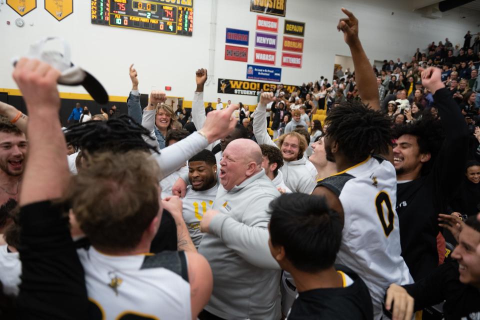 Wooster coach Doug Cline celebrates with his team and students after clinching the outright NCAC title.
