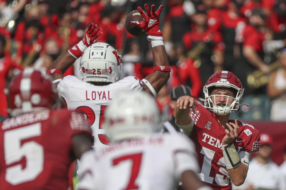 Rutgers defensive back Shaquan Loyal (25) picks off Temple quarterback E.J. Warner (13) before returning for a touchdown in the second quarter of an NCAA college football game at Lincoln Financial Field in Philadelphia on Saturday, Sept. 17, 2022. (Heather Khalifa/The Philadelphia Inquirer via AP)