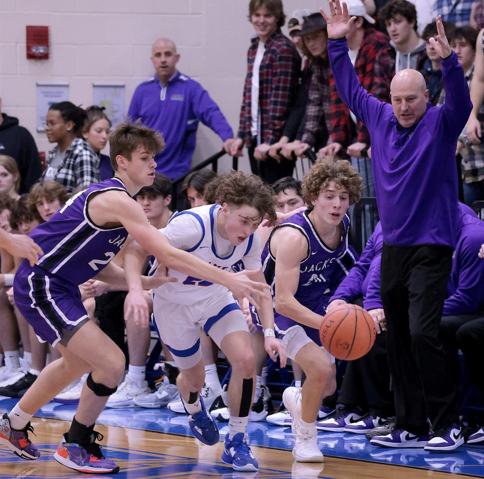 Lake's Chance Casenhiser fights for a loose ball in the second half with Jackson's Kyle Monterrubio (left) and Anthony Fuline during Friday's game.