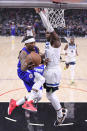 Los Angeles Clippers guard Eric Bledsoe, left, passes the ball as Minnesota Timberwolves forward Anthony Edwards defends during the first half of an NBA basketball game Monday, Jan. 3, 2022, in Los Angeles. (AP Photo/Mark J. Terrill)