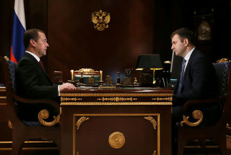 Russian Prime Minister Dmitry Medvedev (L) meets with newly appointed Economy Minister Maxim Oreshkin at the Gorki state residence outside Moscow, Russia, November 30, 2016. Sputnik/Pool/Ekaterina Shtukina via REUTERS