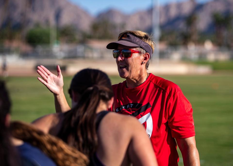 Coach Dani Oswood talks with her players after a water break during practice at Palm Desert High School in Palm Desert, Calif., Thursday, Sept. 14, 2023.