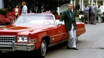Palmer leans on a red Cadillac in his Grenn Jacket during the 1973 Masters Tournament at Augusta National Golf Club.