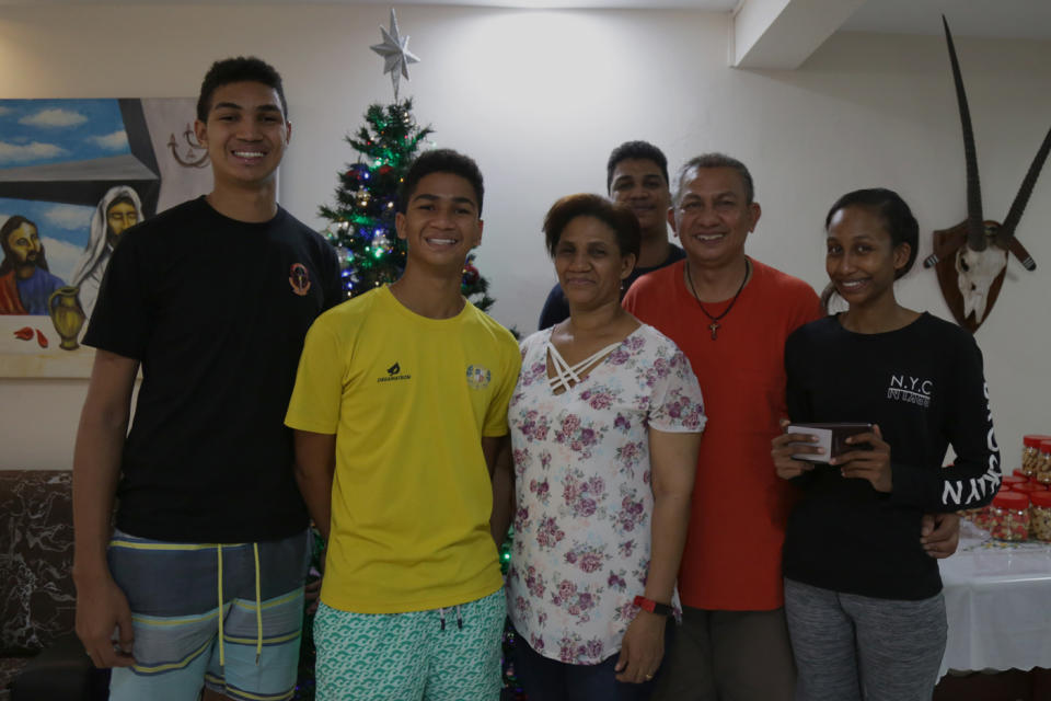 Gerard Nonis (in red), 55, and his wife, Susanna Daniel (in white), 52, have four children of their own – three sons aged 27, 20, and 15, as well as a 25-year-old daughter . (PHOTO: Dhany Osman/Yahoo News Singapore)
