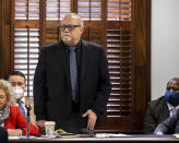 Greg McMichael. center, stands to be recognized during jury selection for the trial of he and his son Travis McMichael and William "Roddie" Bryan, at the Glynn County Courthouse, Monday, Oct. 25, 2021, in Brunswick, Ga. The trio are charged with the slaying of 25-year-old Ahmaud Arbery in February 2020. (AP Photo/Stephen B. Morton, Pool)