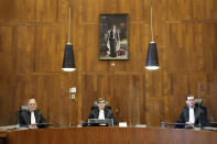 Presiding judge Boele, center, prepares to read the verdict in an appeals court in The Hague, Netherlands, Tuesday Dec. 7, 2021, after a Hague District Court had ruled in January 2020 that the case against Benny Gantz and former Israeli air force commander Amir Eshel could not proceed because the men have "functional immunity from jurisdiction". The case was brought by Ismail Ziada, a Dutch-Palestinian who lost six members of his family in the airstrike that lawyers for the men argued was part of an Israeli military operation during the 2014 Gaza conflict. (AP Photo/Peter Dejong)