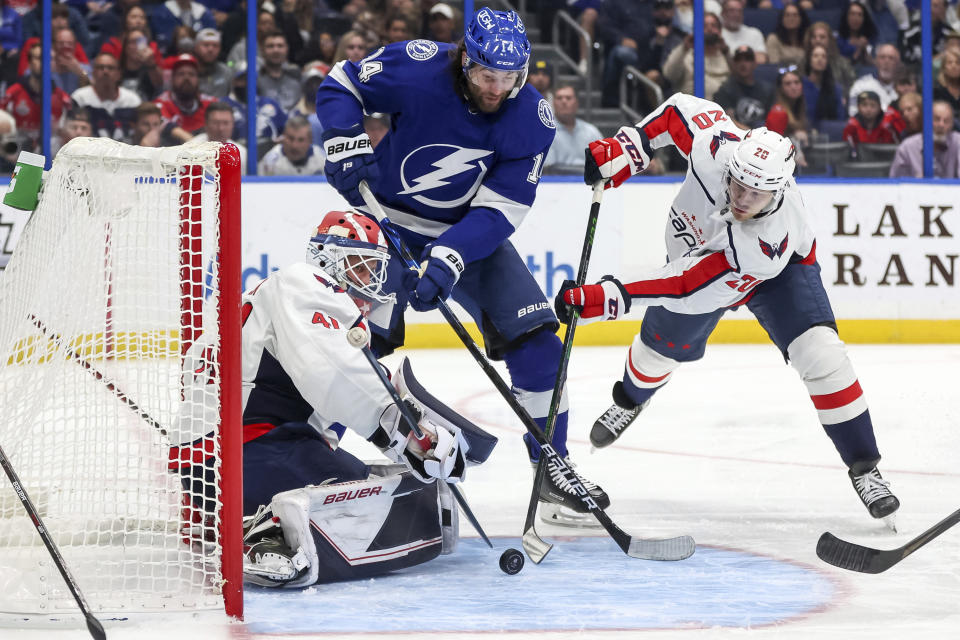 Washington Capitals goaltender Vitek Vanecek, of Czech Republic, makes a save against Tampa Bay Lightning's Pat Maroon as Lars Eller, of Denmark, defends during the second period of an NHL hockey game Monday, Nov. 1, 2021, in Tampa, Fla. (AP Photo/Mike Carlson)