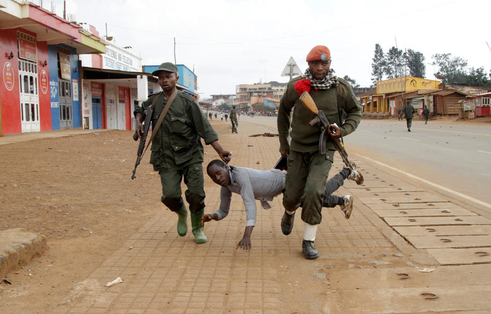 Congolese soldiers arrest a civilian protesting