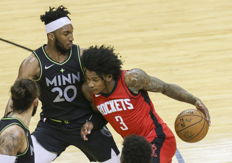 Houston Rockets guard Kevin Porter Jr. (3) dribbles against Minnesota Timberwolves forward Josh Okogie (20) during the third quarter of an NBA basketball game Tuesday, April 27, 2021, in Houston. (Thomas Shea/Pool Photo via AP)