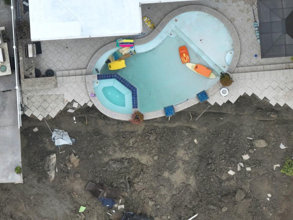 A pool was mostly drained to prevent more movement after four cliff-side, ocean-view apartment buildings were evacuated