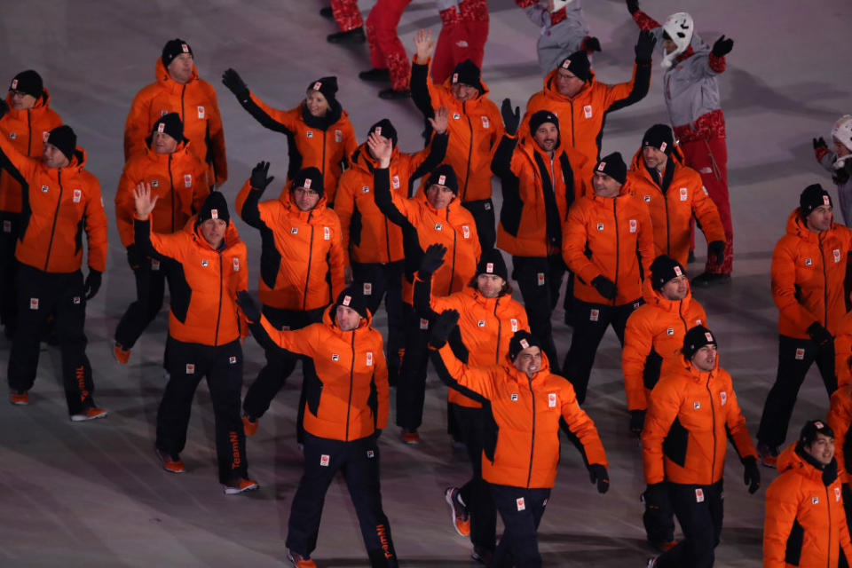 <p>Team Netherlands walks in the Parade of Athletes wearing orange winter jackets anad black pants designed by Fila during the opening ceremony of the 2018 PyeongChang Games. (Photo: Sean M. Haffey/Getty Images) </p>