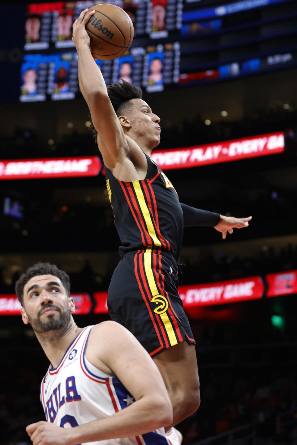 Atlanta Hawks forward Jalen Johnson dunks over Philadelphia 76ers forward Georges Niang during the first half of an NBA basketball game Friday, April 7, 2023, in Atlanta. (AP Photo/Alex Slitz)