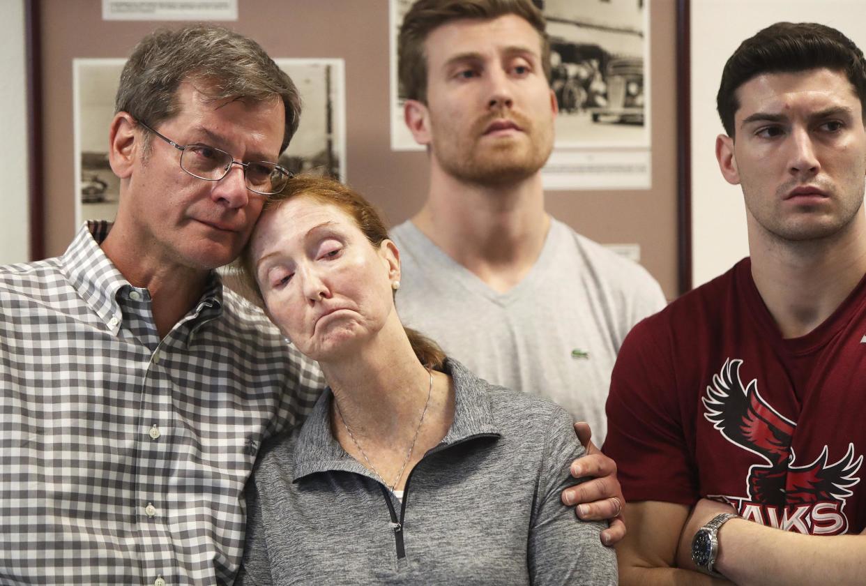 Parents John and Lisa Dombroski, left, stand with their sons John, behind, and Kevin during a press conference regarding their son and brother Mark: Blaire Simmons/The Royal Gazette via AP