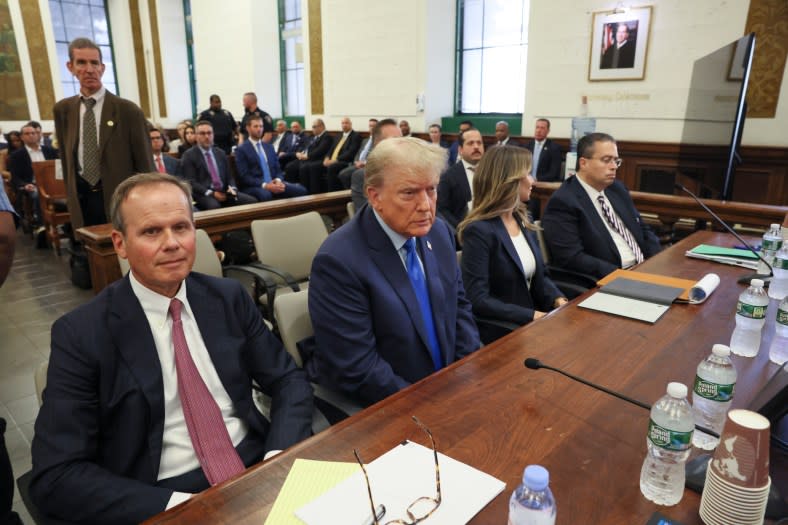 Former President Donald Trump, center, appears in court Monday, Oct 2, 2023, in New York. (Photo by Brendan McDermid/Pool Photo via AP)