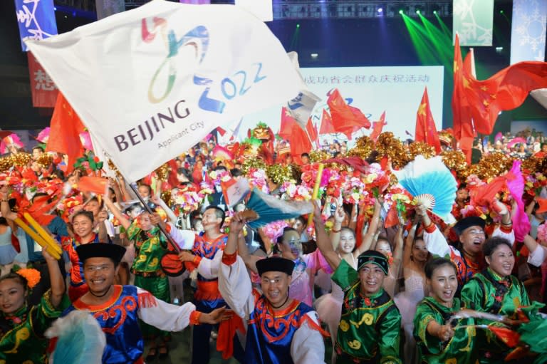 People wearing traditional costumes gather to celebrate as Beijing is announced as the host city for the 2022 Winter Olympic Games, in Shijiazhuang, the capital of northern China's Hebei province on July 31, 2015