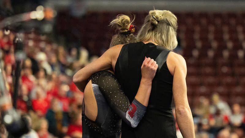 Utah Utes Abby Paulson hugs head coach Carly Dockendorf during the Sprouts Farmers Market Collegiate Quads at Maverik Center in West Valley on Saturday, Jan. 13, 2024. #1 Oklahoma, #2 Utah, #5 LSU, and #12 UCLA competed in the meet.