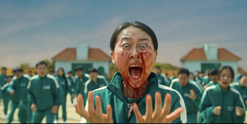 A woman screaming as she's covered in blood