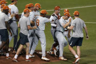 Texas players celebrate their win over South Florida in an NCAA Super Regional college baseball game, Sunday, June 13, 2021, in Austin, Texas. (AP Photo/Eric Gay)