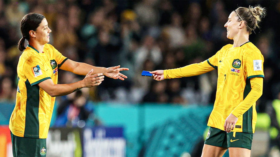 Steph Catley is seen passing over the captain's armband to Sam Kerr.