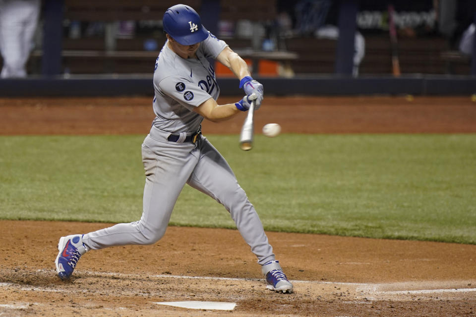 Los Angeles Dodgers' Walker Buehler hits a double during the third inning of a baseball game against the Miami Marlins, Monday, July 5, 2021, in Miami. (AP Photo/Wilfredo Lee)