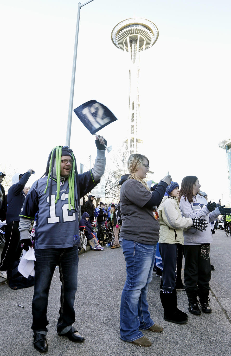 Seattle Seahawks fans wait for the team's Super Bowl championship parade to begin on Wednesday, Feb. 5, 2014, in Seattle. The Seahawks beat the Denver Broncos 43-8 in the NFL Super Bowl XLVIII football game on on Feb. 2, 2014. (AP Photo/Elaine Thompson)