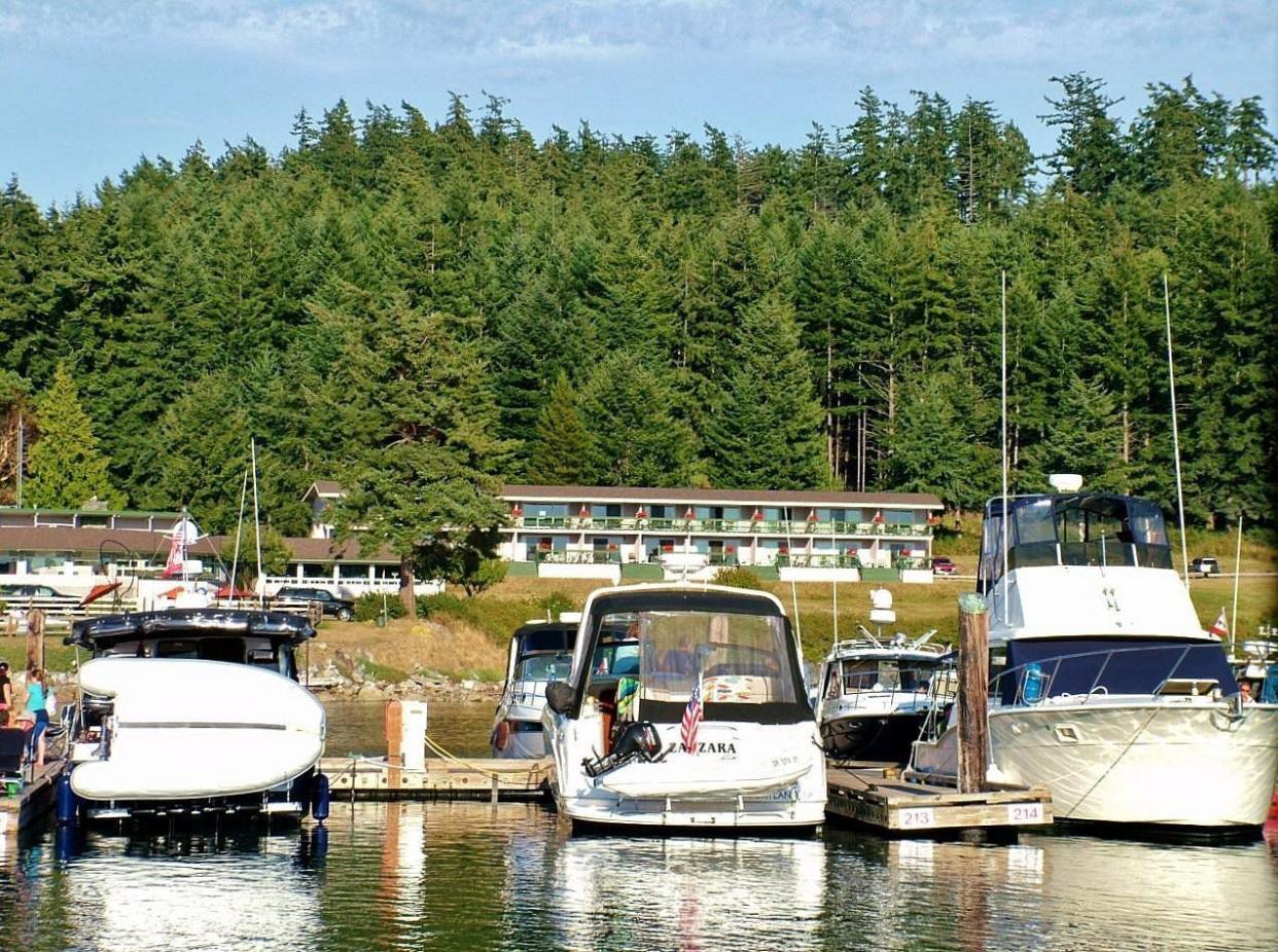 Closeup of boats in harbor with restaurant and lodging in tbe background at the Lopez Islander Resort, Lopez Island, Washington