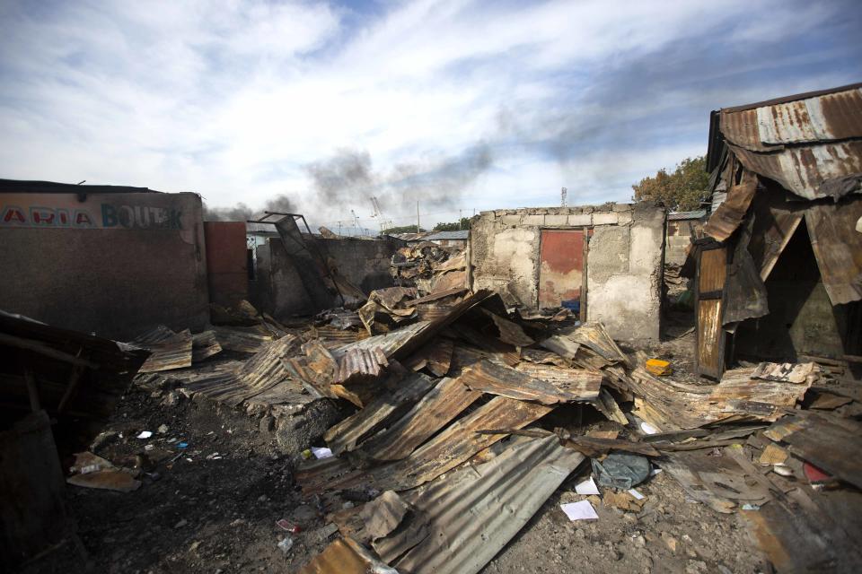 In this Nov. 21, 2018 photo, homes that were burned to the ground during a massacre lay in ruins in the La Saline slum of Port-au-Prince, Haiti. Around three in the afternoon on November 13th, men in police uniforms entered the neighborhood, going house to house, pulling unarmed people into the narrow alleys and executing them with single shots. (AP Photo/Dieu Nalio Chery)