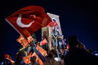 Pro-Erdogan supporters wave Turkish flags during a rally against the military coup on Taksim square in Istanbul on July 23, 2016