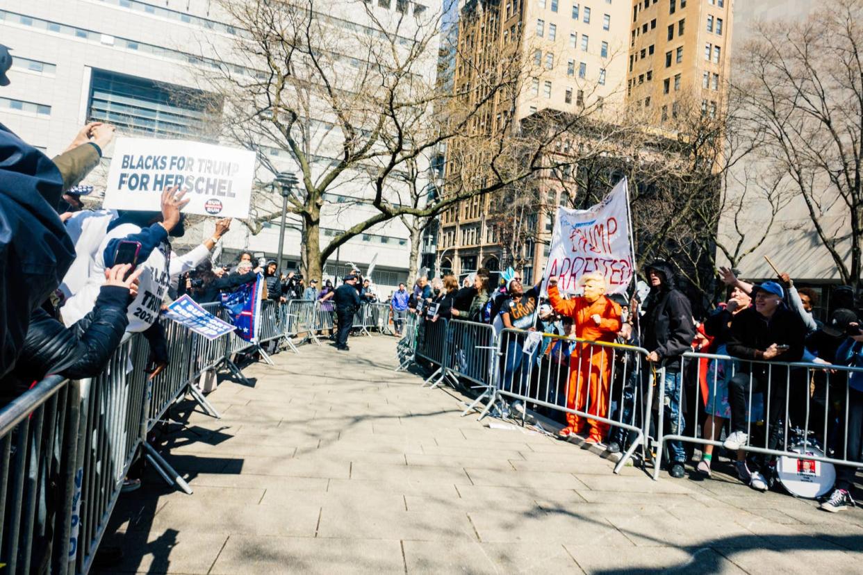 Supporters and opponents of former president Donald Trump gather outside the Manhattan Criminal Court ahead of his arraignment on April 4, 2023.