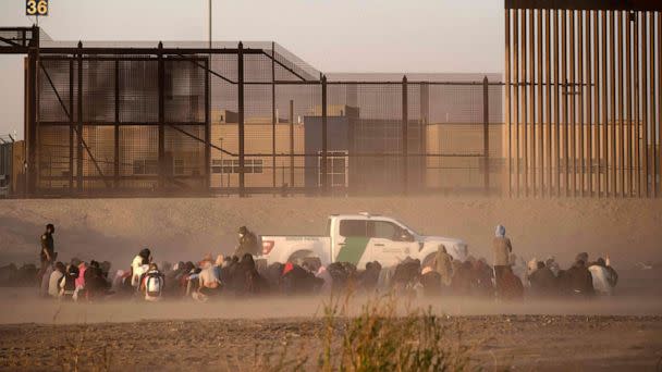 PHOTO: Migrants wait to be processed by United States Border Patrol seen from Ciudad Juarez, Chihuahua state, Mexico, on March 30, 2023. (Guillermo Arias/AFP via Getty Images)