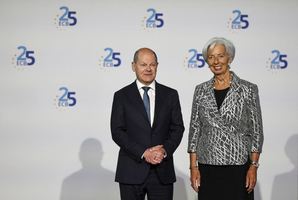 European Central Bank president Christine Lagarde, right, welcomes German Chancellor Olaf Scholz during a ceremony to celebrate the 25th anniversary of the ECB, in Frankfurt, Germany, Wednesday May 24, 2023. (Kai Pfaffenbach/Pool via AP)