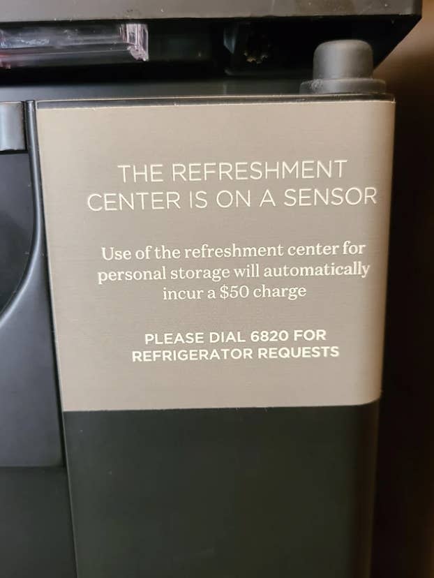 Sign saying use of refreshment center will incur a "$50 charge"