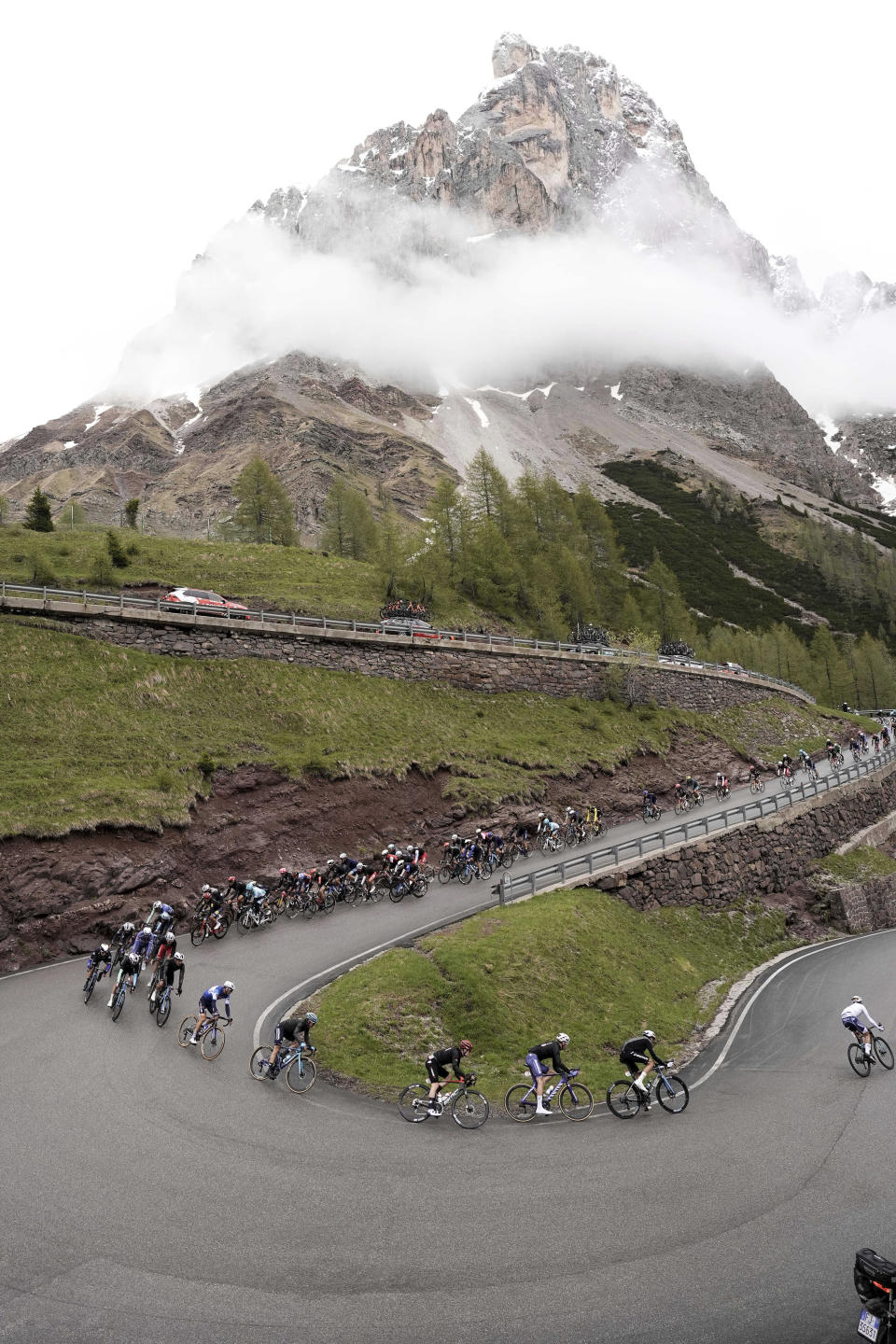 The pack of riders pedals during the 17th stage of the Giro d'Italia from Selva di Val Gardena to Passo Brocon, Italy, Wednesday, May 22, 2024. (Fabio Ferrari/LaPresse via AP)