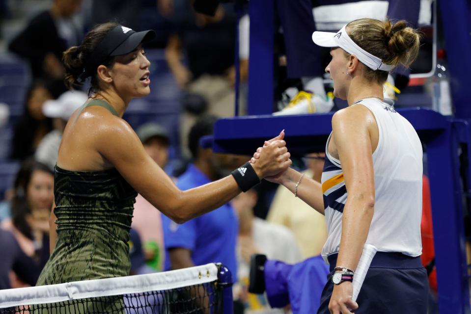 Barbora Krejčíková of Czech Republic (R) shakes hands with Garbine Muguruza of Spain (L) after their match on day seven of the 2021 US Open.