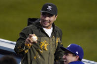 A fan turns around after being sprayed with nacho sauce when a ball hit for a solo home run by Los Angeles Dodgers' Justin Turner landed in his nachos during the third inning of a baseball game against the Colorado Rockies Wednesday, April 14, 2021, in Los Angeles. (AP Photo/Mark J. Terrill)