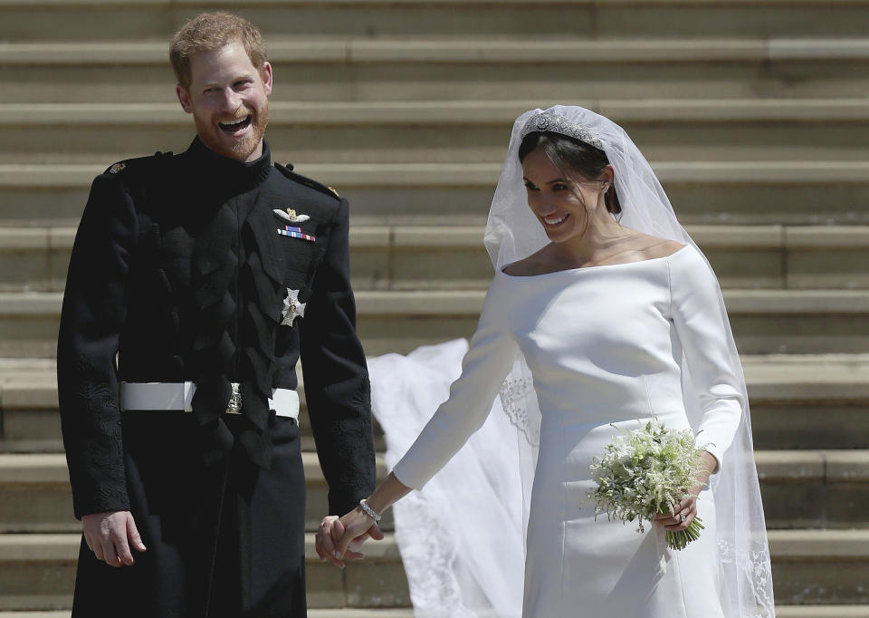 FILE - In this Saturday, May 19, 2018 file photo Meghan Markle and Britain's Prince Harry stand on the steps of St George's Chapel at Windsor Castle following their wedding in Windsor, near London, England. (Jane Barlow/pool photo via AP, File)