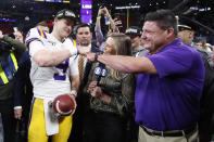 FILE - In this Dec. 7, 2019, file photo, LSU quarterback Joe Burrow and LSU head coach Ed Orgeron celebrate after the Southeastern Conference championship NCAA college football game against Georgia, in Atlanta. Orgeron is The Associated Press Coach of the Year after leading the top-ranked Tigers to a Southeastern Conference championship and their first College Football Playoff appearance.(AP Photo/John Bazemore, File)