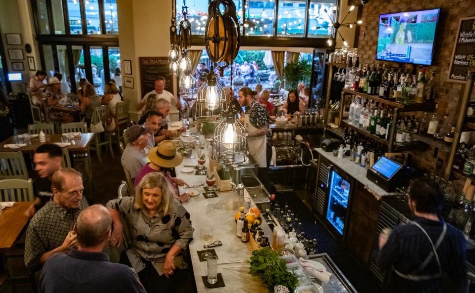 Patrons visiting Mercato in Naples enjoy the atmosphere at Bar Tulia Saturday evening, January 27, 2024.