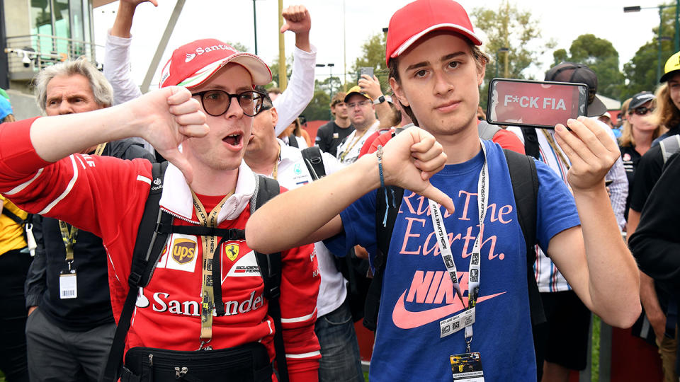 Formula One fans, pictured here looking furious after the Australian Grand Prix was cancelled.