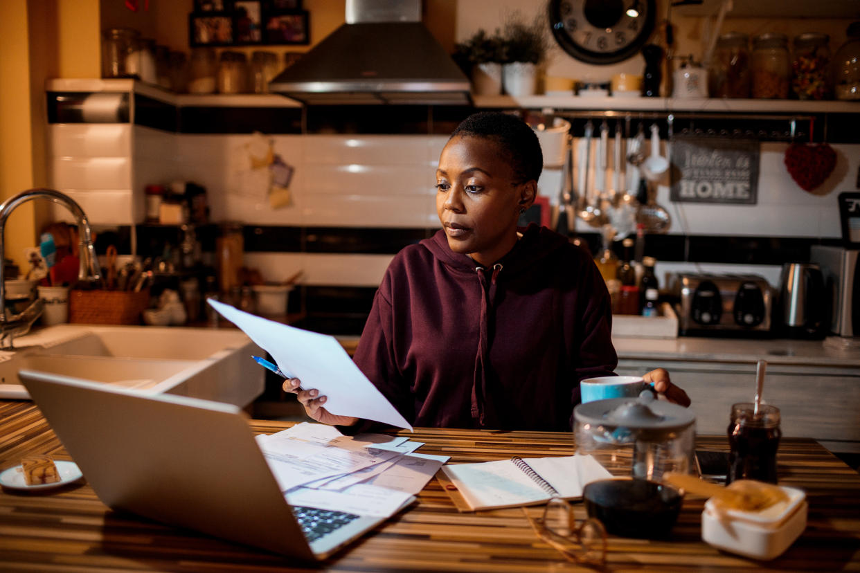 Close up of a young woman doing her home finances in the evening