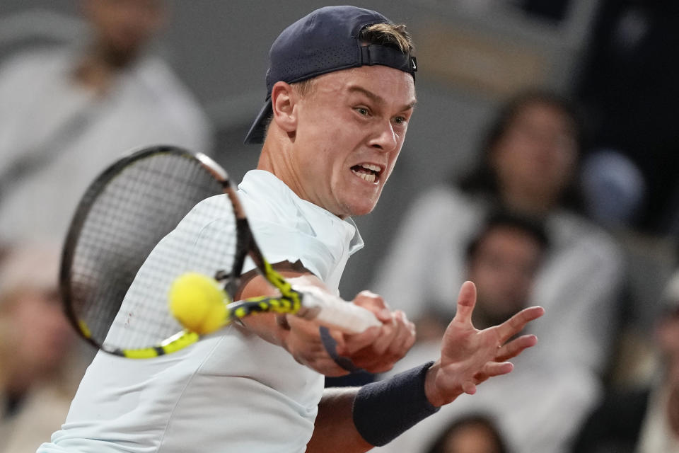 Denmark's Holger Rune plays a shot against Germany's Alexander Zverev during their fourth round match of the French Open tennis tournament at the Roland Garros stadium in Paris, Monday, June 3, 2024. (AP Photo/Thibault Camus)