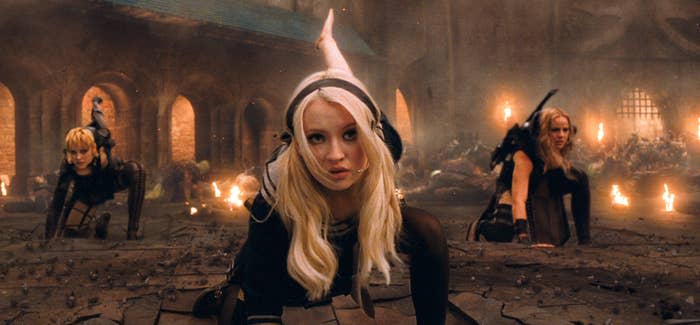 Three characters, including Babydoll, from the film "Sucker Punch" engaging in an action scene, with Babydoll in the center foreground